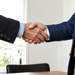 ** A real estate agent shaking hands with a client, symbolizing a successful property deal. Focus on trust and professionalism.

**